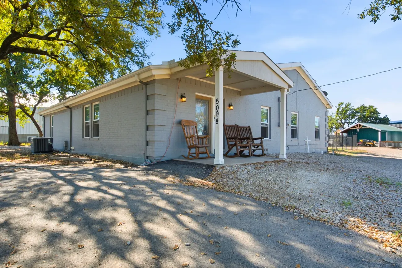 Covered front porch with two wooden rocking chairs