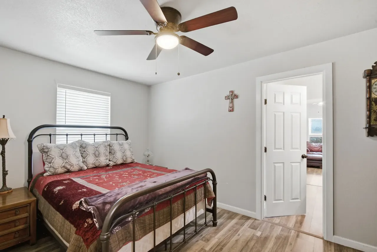 Second bedroom with the iron bed, a nightstand and a door to the hall