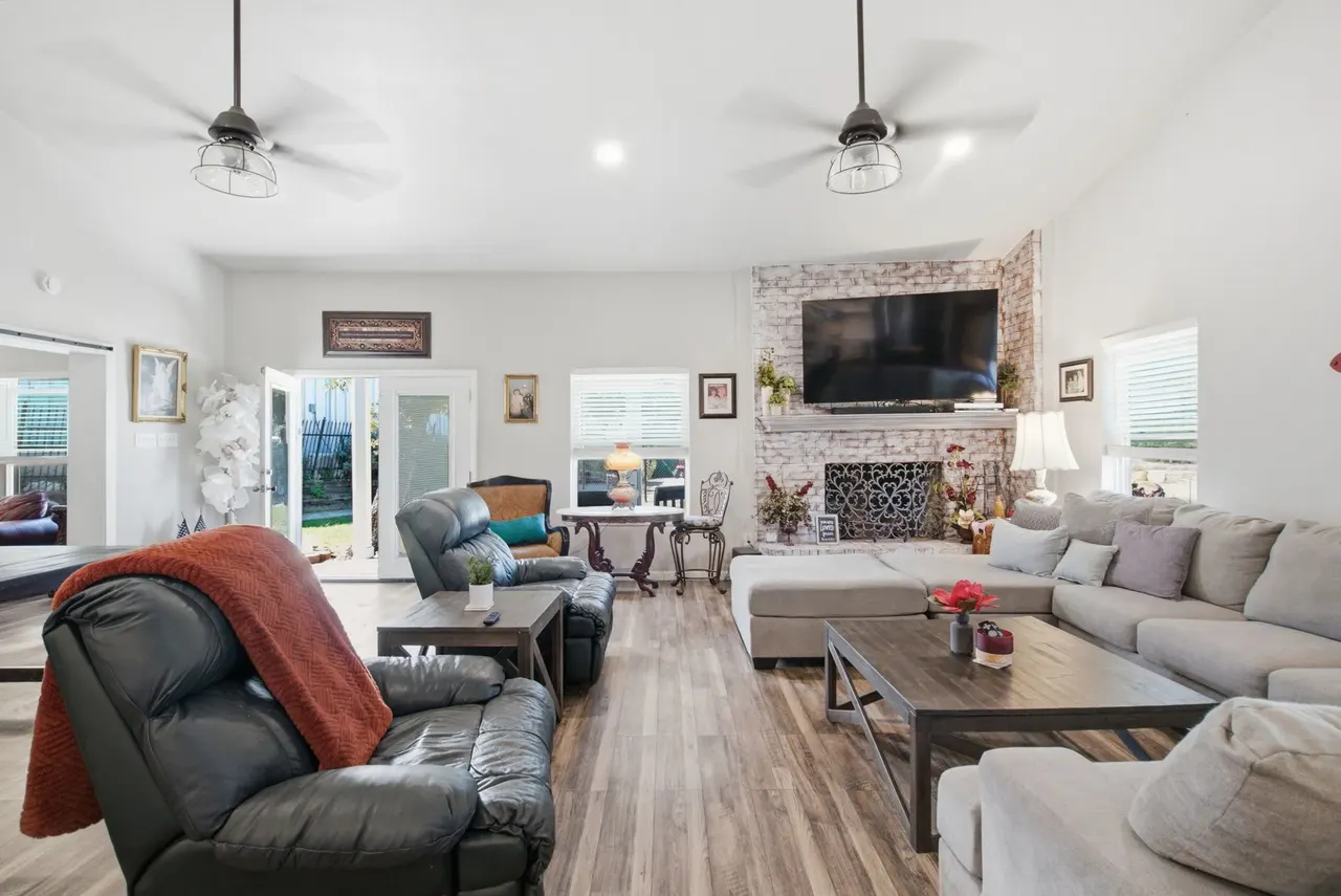 Living room with recliners, the fireplace and French doors to the back yard