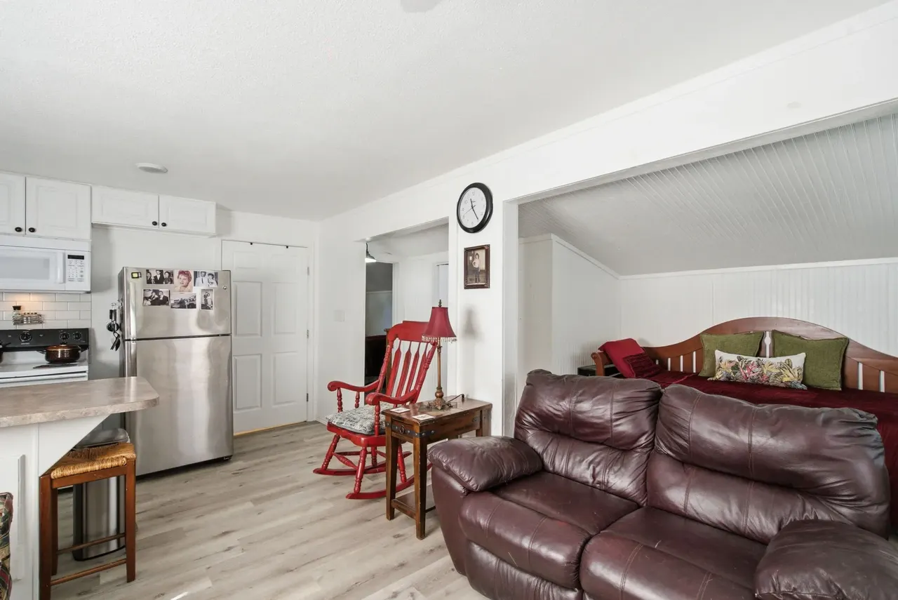 Cottage living room with a leather sofa, rocking chair and kitchen counter