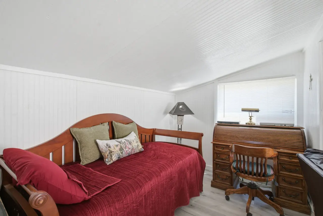 Cottage room with a wooden daybed and a roll-top desk